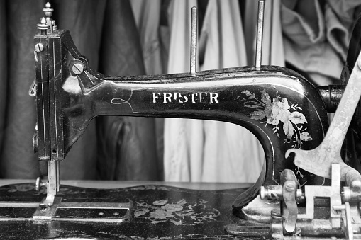 London, United Kingdom - May 7, 2011: Antique hand crank sewing machine, manufactured by Frister & Rossmann, circa 1890 to 1910. Frister & Rossmann began in Germany in 1864. This machine is in the widow of an AllSaints Spitalfields Store on Portobello Road, Notting Hill, London, United Kingdom