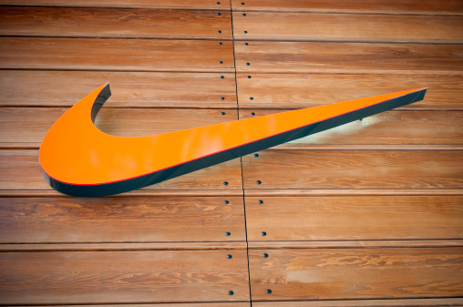 London, United Kingdom - April 22, 2011: Nike store logo located in central London, near Covent Garden. The Nike Swoosh logo hanging from a house wall. Nike is a global sports clothes and running shoes retailer. Nike stores are located all over London. Covent Garden is a famous shopping area and tourist hot-spot.