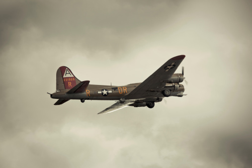 Seattle, US - June, 20 2009: A worldwar 2 era Boeing B-17 Flying Fortress moments after take off.  This B-17 is restored to its original state and gives flight tour around the country.  Photo is sepia processed for a retro look.  Taken at Seattle Museum of Flight, Boeing Field.