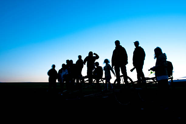 Inner Mongolia, China - July 16, 2009: A group of tourists taking photos at dusk on the grassland of Inner Mongolia, China. More and more Chinese are taking self driving tour in their holiday.