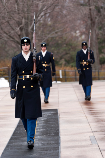 Arlington, Virginia,USA - December 25, 2010: Three US Army soldiers (honor guards) at attention at the tomb of the unknown soldier, in Arlington National Cemetery, Virginia, USA. It is the change of guard on christmas day 2010