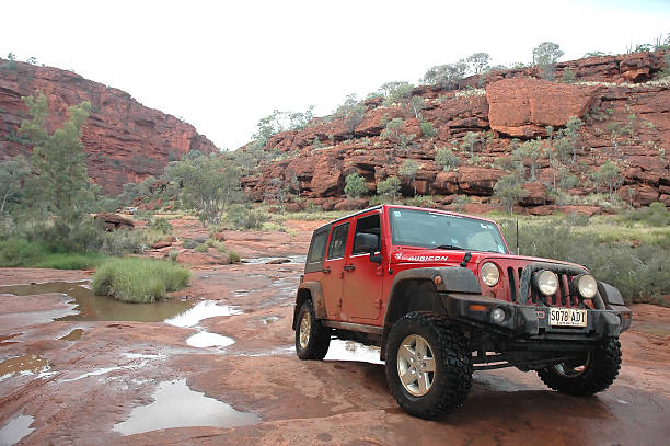 Red Jeep Wrangler, 4x4, 4wd, offroad, Palm Valley, Northern Territory Palm Valley, Northern Territory, Australia - July 12, 2010: Red Jeep Wrangler (JK model)  on rocks at Palm Valley, Northern TerritoryOnly 4x4 vehicles can acces this beautiful but remote part of the Northern Territory of Australia 4x4 stock pictures, royalty-free photos & images