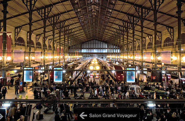 2019 Gare du Nord Station Paris, France. This is  a Eurostar station and has a number of passengers on the platform heading towards their train carriage.