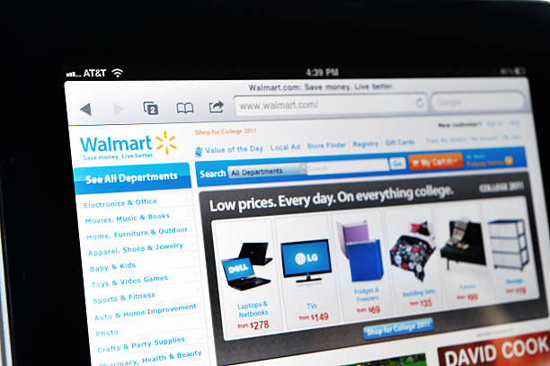 iPad Displaying Walmart Web Site Raleigh, NC - USA - June 27, 2011: Woman Holding an iPad Displaying Walmart Web Site. how to sell my photography online stock pictures, royalty-free photos & images