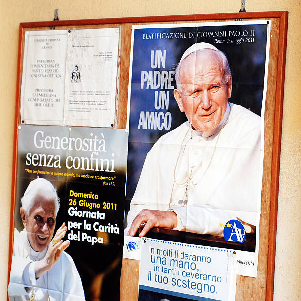 Popes Borgosesia, Italy - July 6, 2011: Popes of the Catholic Church: John Paul II  (Pontificate from 16 October 1978 to 2 April 2005) on the right and Benedict XVI (current) on the left on posters outside an Italian church in Borgosesia. pope john paul ii stock pictures, royalty-free photos & images