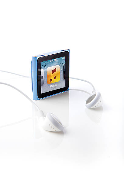 6th Generation Apple iPod Nano Portland, Oregon, USA - October 10, 2011: 6th Generation Apple iPod Nano with Multi-Touch technology. Shown here with the Apple Earbuds that come standard with each unit. ipod nano stock pictures, royalty-free photos & images
