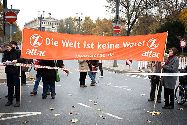 Frankfurt, Germany - November 12, 2011: Protestors with an attac-banner at the 'Banken in die Schranken'-demonstration in the financial district of Frankfurt. The demonstration was - among others - organized by attac and Occupy Frankfurt, a german division of the international Occupy movement that began in New York as Occupy Wall Street.