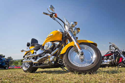 Boryszyn, Poland - May 19, 2012: Harley Davidson motorcycle on a field against blue sky during Motorcycle Rally. Harley Davidson is an American motorcycle manufacturer. Founded in Milwaukee, Wisconsin, during the first decade of the 20th century.