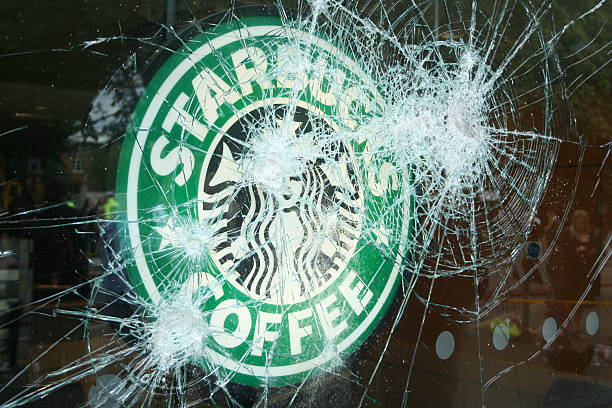 Starbucks - Broken Window "Ealing, London - August 9, 2011: The morning after rioting and looting took place in London and Starbucks was one of many shops, cafes and restaurants that were damaged." eanling stock pictures, royalty-free photos & images