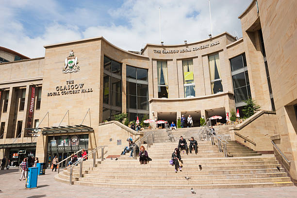 Glasgow Royal Concert Hall Glasgow, UK - May 19, 2011: People sitting on the steps at the entrance to the Glasgow Royal Concert Hall on the pedestrian precinct where Sauchiehall Street and Buchanan Street meet in Glasgow city centre. Designed by Sir Leslie Martin it was built in the late 1980s. editorial architecture famous place local landmark stock pictures, royalty-free photos & images