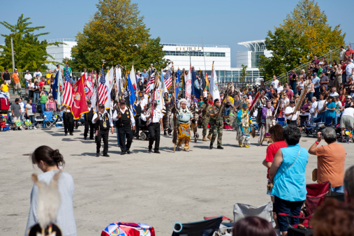 Milwaukee, Wisconsin- September 12,2009: the Grand Entry- the beginning of Pow Wow at the Indian Summer Fest- the flags ( American flag, tribal flags, Pow Wow flag, etc) are carried by the Veterans, followed by the tribal chiefs, Princesses, elders, and Pow Wow organizers as well as  Native dancers.