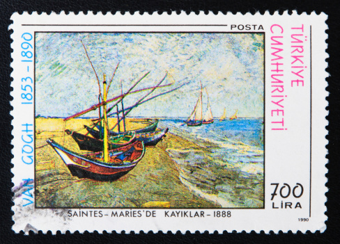 Istanbul, Turkey - November 18, 2011: Close-up of a Turkish stamp showing an image of the Fishing Boats on the Beach at Saintes-Maries painting by the Dutch post-Impressionist painter Vincent Willem Van Gogh.