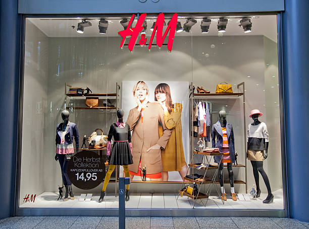 Hennes and Mauritz shop window Berlin, Germany - August 22, 2011: The exterior of the H&amp;M store at the Potsdamer Platz Shopping Mall in Berlin, Germany. The clothes on display represent their 2011 Fall Collection. H&amp;M is a Swedish clothing company with over 2,200 stores worldwide. h and m stock pictures, royalty-free photos & images