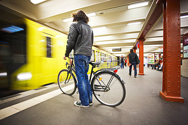 Berlin, Germany - April 23, 2012: Man with bike waiting for a subway train on Alexanderplatz subway station in Berlin.