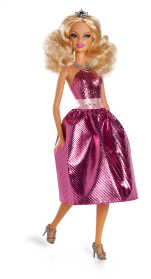 San Diego, California, United States - March 6th 2011: This is a photo taken in the studio of Princess Barbie Doll isolated on a white background. She is wearing a pink glitter dress and crown and is configured in a walking position.