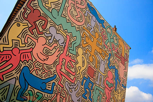 Tuttomondo (Keith Haring mural), Pisa, Italy Pisa, Italy - August 10, 2010: \"Tuttomondo\" by  Keith Haring. Keith Haring painted the last public work of his life \"Tuttomondo\" on the rear wall of the convent of the Church of Sant\'Antonio in Pisa in June 1989. The theme of this mural is that of peace and harmony in the world. pisa stock pictures, royalty-free photos & images