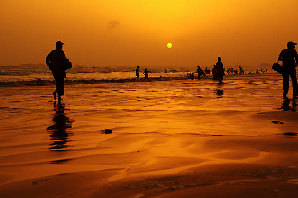 Karachi, Pakistan - May 22, 2010: Karachiites cooling down the warm day at Clifton Beach in Karachi, Pakistan. Clifton beach a.k.a Seaview is most popular local silver sand beach in Karachi visited by thousands of visitors every day. Camel and horse rides along the beach are very popular with tourists.