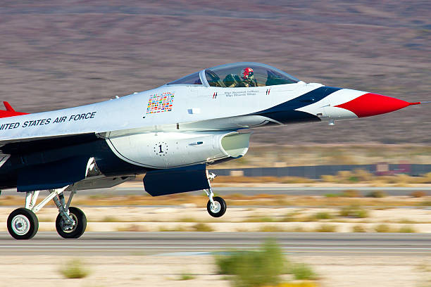 USAF Thunderbirds "Las Vegas, USA - November 13, 2010:  United States Air Force Thunderbirds Demonstration Squadron flying in formation presentic characteristics od F-16 Fighting Falcon pinted in the famous blue red and white color which are also colors of the Flag of the United States of America" supersonic airplane editorial airplane air vehicle stock pictures, royalty-free photos & images