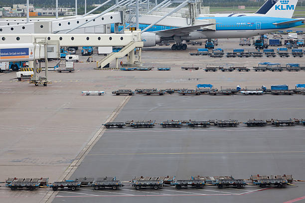 Schiphol airport, Amsterdam, Holland - August 4 2011:  Scene at a terminal at Schiphol airport, Amsterdam, Netherlands. Departure gates, ground support vehicles and plane seen at the terminal.