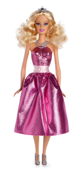 San Diego, California, United States - March 6th 2011: This is a photo taken in the studio of Princess Barbie Doll isolated on a white background. She is wearing a pink glitter dress and crown. The Barbie Doll was invented in 1959 by Mattel Inc. Barbie dolls are sold in over 140 countries, and about two dolls are sold every second.