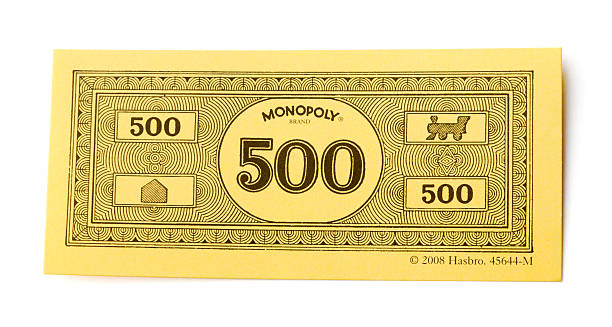 Belen, New Mexico, USA - June 4, 2011: A paper 500 dollar bill which is one denomination used as the currency in the game Monopoly. The other denominations used in the game are $100, $50, $20, $10, $5 and $1. Monopoly is a property trading game published by Parker Brothers, a subsidiary of Hasbro.