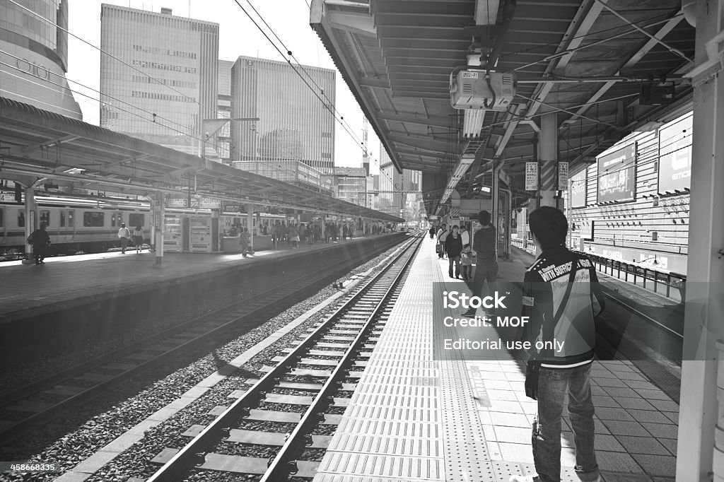 Subway station Tokyo Japan Tokyo, Japan - November 3, 2010: Subway station Tokyo Japan with people waiting for a train at an empty platform Black And White Stock Photo