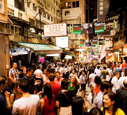 Hong Kong, China - September 30, 2011: People talking on the street at Lan Kwai Fong a very popular nightlife area in Hong Kong were many bars and discos are located. Specially on the weekends the street gets very crowded  till late at night.