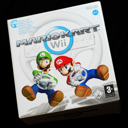 Liverpool, England - March 21, 2011: Mario Kart Wii game box for Nintendo Wii videogame console on black, studio shot. Mario Kart Wii​ is a racing game, featuring the famous Nintendo characters Mario and Luigi and others, published by Nintendo for the Wii console.
