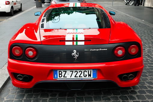 Rome, Italy - May 2, 2011: Rear view of a red Ferrari 360 Challenge Stradale, parked on street in the Via Veneto.