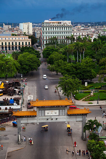 Habana, Cuba - September 7, 2011: Pedestrians cross the archway that stabilishes the chinese district - Barri Chino, in spanish - entrance in Habana.