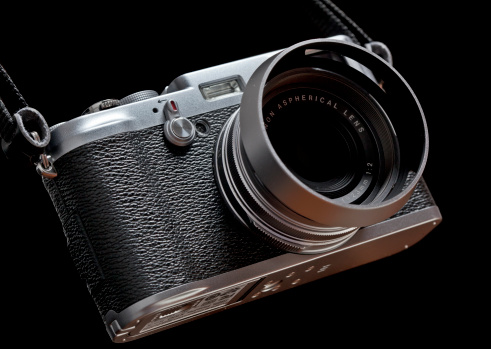 New York, USA - May 14, 2011: Studio product shot of a Fujifilm Finepix X100 camera on a black background.