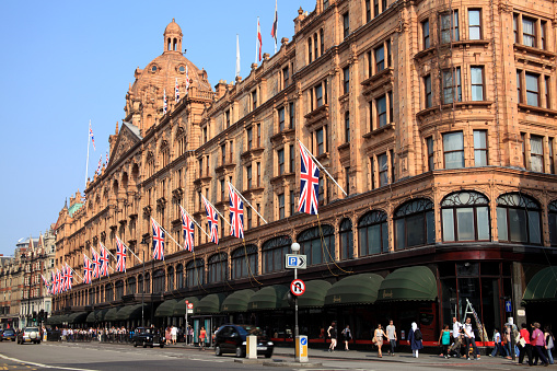 London, United Kingdom - April 24, 2011: Exterior of Harrods department store in the Brompton Road, Knightsbridge showing shoppers passing by.