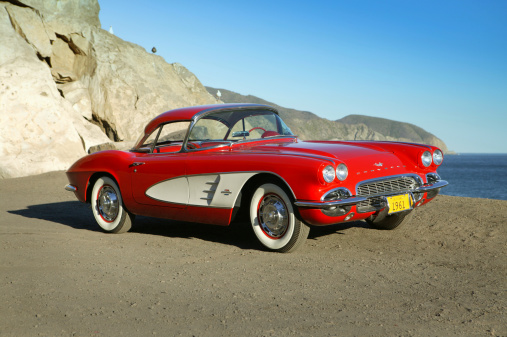 Malibu, California USA- October 5,2005: 1961 Chevy corvette parked at the beach side in Malibu CA on PCH at sunset. First introduced in 1953 this model ran till 1962 then was replaced by the stingray.