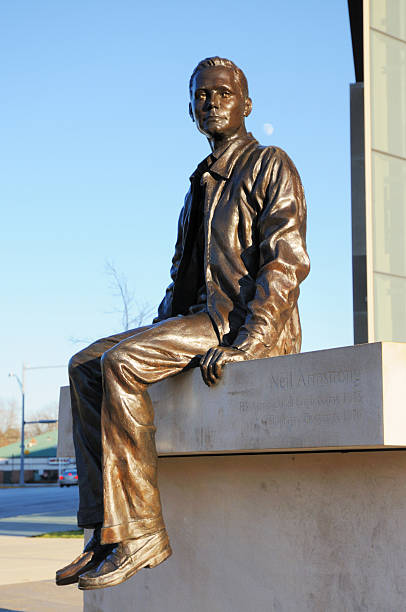 West Lafayette, Indiana, USA - November 28th, 2009:  The Neil Armstrong Statue in front of the Armstrong Hall of Engineering on Purdue Univiersity\\'s main campus in West Lafayette, Indiana.  Armstrong was a Purdue graduate and the first man to walk on the Moon.  The Moon is visible over the statue\\'s left shoulder.