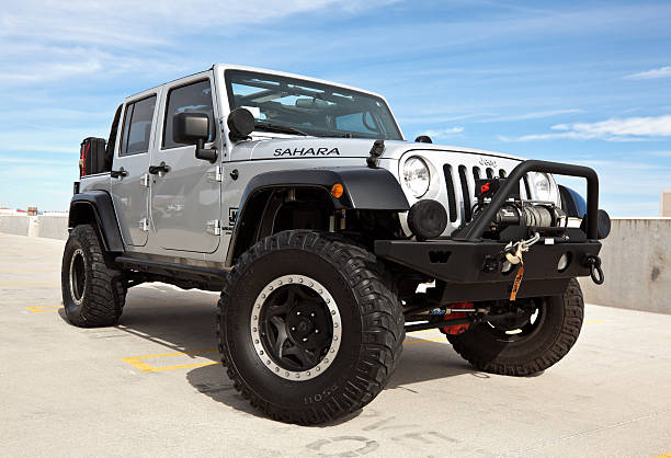 Jeep Wrangler 2008. Scottsdale, United States - November 10, 2011: A parked silver 2008 Jeep Wrangler, this particular Jeep has a custom shock kit and winch and is known as the Sahara edition. cable winch stock pictures, royalty-free photos & images