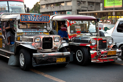 Manila, Philippines - April 19, 2012: Jeepney Traffic in central Manila during rush hour. People can be seen onboard.