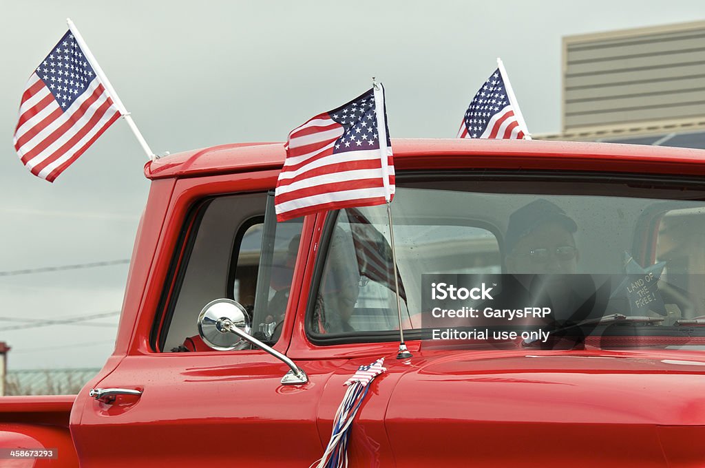 Veterans Parade The Dalles Oregon Classic Red Chevrolet Pickup Cab "The Dalles, Oregon, USA - November 12, 2012: An older red Chevrolet Pickup Truck proudly displays the American Flag. This is part of the annual Veteran's parade held in The Dalles." Parade Stock Photo