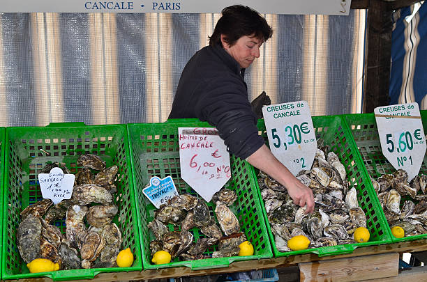 France, Brittany "Cancale, France - June 10th 2011: oyster sale on a street market in the village of Cancale in Brittany" cancale photos stock pictures, royalty-free photos & images