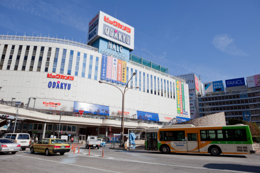 Tokyo, Japan - November 26, 2011: Pedestrians walk past Shinjuku District in Tokyo, Japan. Odakyu Department Store is on the western side of Shinjuku Station. The department store belongs to the Odakyu Group. Bic Camera, a japanese famous camera shop also in this department store.