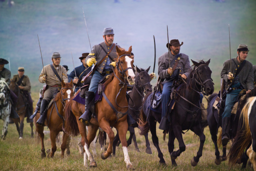 Middletown, USA - October 16, 2005: A large number of reenactors playing the parts of Confederate cavalrymen during the US Civil War are riding across the Cedar Creek Battlefield in the Shenandoah Valley of Virginia during a recreation of the Battle of Cedar Creek..  The actual battle itself took place on October 19, 1864.