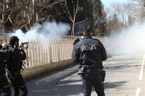 Turkish Riot Police "Istanbul, Turkey - March 18, 2012: Turkish police released gas bomb at Newroz demonstrations. Kurds celebrating their traditional feast Newroz that means 'new day' in kurdish on March 18, 2012 in Istanbul, Turkey." tear gas stock pictures, royalty-free photos & images