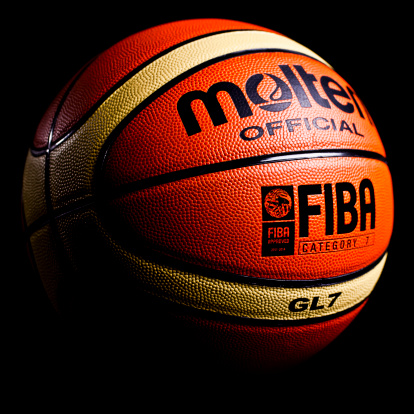 Ljubljana, Slovenia - September 13, 2011: Molten GL7 Official FIBA leather indoor basketball, isolated on black. Molten is Japanese sporting goods manufacturer which provides basketballs for Olympic games, FIBA championships and many national leagues.