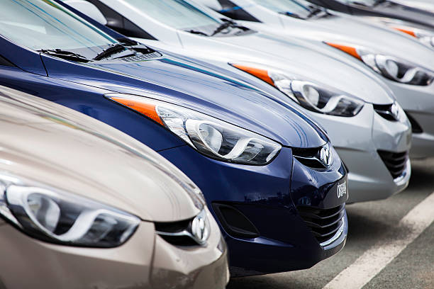 Dartmouth, Nova Scotia, Canada - September 9, 2012: Various colors of new Hyundai Elantra vehicles sit in a row on a car dealership lot displaying the front fascia of the vehicles.  The Hyundai Elantra is a hatchback vehicle manufactured by Hyundai.  The new GT version was released for the 2013 model year and features an all-new look.