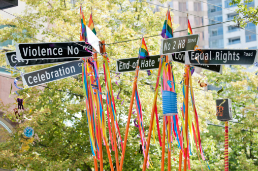 Vancouver, British Columbia, Canada - July 31, 2011: Signs with the words &amp;amp;amp;amp;amp;ldquo;Violence No Way&amp;amp;amp;amp;amp;rdquo;, &amp;amp;amp;amp;amp;ldquo;No 2 H8 Street&amp;amp;amp;amp;amp;rdquo;, &amp;amp;amp;amp;amp;ldquo;Equal Rights Road&amp;amp;amp;amp;amp;rdquo; and parts of &amp;amp;amp;amp;amp;ldquo;Celebration&amp;amp;amp;amp;amp;rdquo; and &amp;amp;amp;amp;amp;ldquo;End of Hate&amp;amp;amp;amp;amp;rdquo;, streamers, ribbons, pride flags, and lanterns in rainbow colours decorate a float at the Vancouver Pride Parade on July 31, 2011.  The annual Vancouver Pride Parade is Western Canada&amp;amp;amp;amp;amp;rsquo;s largest celebration of the LGBTTQ (lesbian, gay, bisexual, transgender, transsexual, transvestite, queer, questioning) community and is in its 33rd year drawing over 600,000 spectators.  This image was taken on Robson Street, Vancouver, British Columbia, Canada, along the parade route.