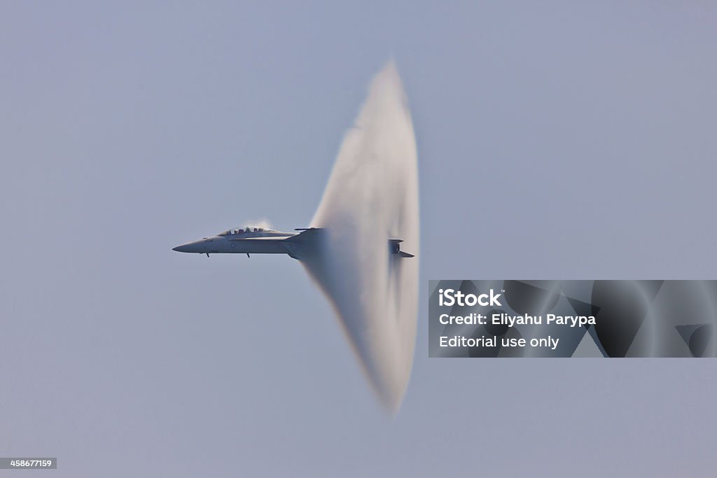 F/A-18 Super Hornet Vapor Cone "Ocean City, USA - June 12, 2011: F/A-18 Super Hornet speed pass with spectacular visible vapor cone which is effect called Prandtl&ndash;Glauert singularity when plane travels with subsonic speed in specific weather condition." Sonic Boom - Natural Phenomenon Stock Photo