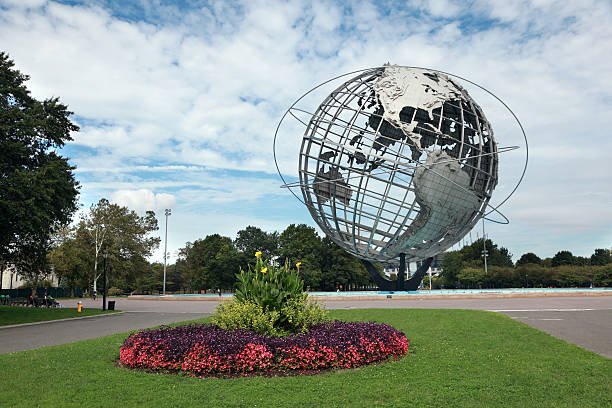 New York City, NY, USA - 22 April 2014: A man in sunglasses looks off camera, the Unisphere globe sculpture on the site of the 1964 World's Fair in New York City.