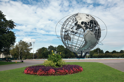 Queens New York, United States of America - September 25, 2011: The Unisphere in Fushing Meadows Corona Park, Queens (New York). The Unisphere is a 12 foot tall, steel representation of the Earth; designed by landscape architect Gilmore D. Clark, the structure was donated by U.S Steel for inclusion in the 1964/1965 New York World\\'s Fair. New York State Pavillion visible in background.