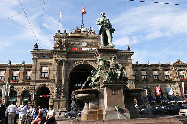 Zurich Train Station Zurich, Switzerland - June 9, 2007: A group of people wait beside the Alfred Escher statue and fountain outside of the Zurich Train Station. esher stock pictures, royalty-free photos & images