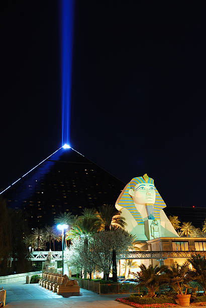 Luxor Hotel, Las Vegas "Las Vegas, Nevada, USA - March 5, 2010: Statue of Sphinx from Luxor Hotel and Casino with light beam light behind on Las Vegas Strip at night." luxor las vegas stock pictures, royalty-free photos & images