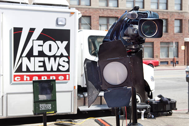 Fox News Truck and Camera on Location Los Angeles, California, USA - March 13, 2011: Fox News Truck and Camera on location parked on a street in downtown Los Angeles. Camera and light setup to record an interview on the street in Little Tokyo. fox stock pictures, royalty-free photos & images